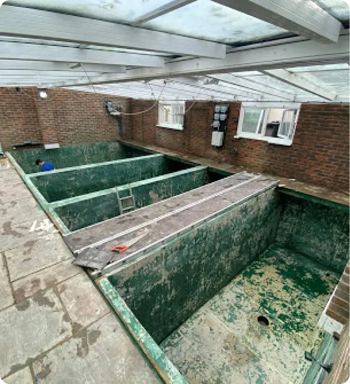 an abandoned swimming pool in a brick building