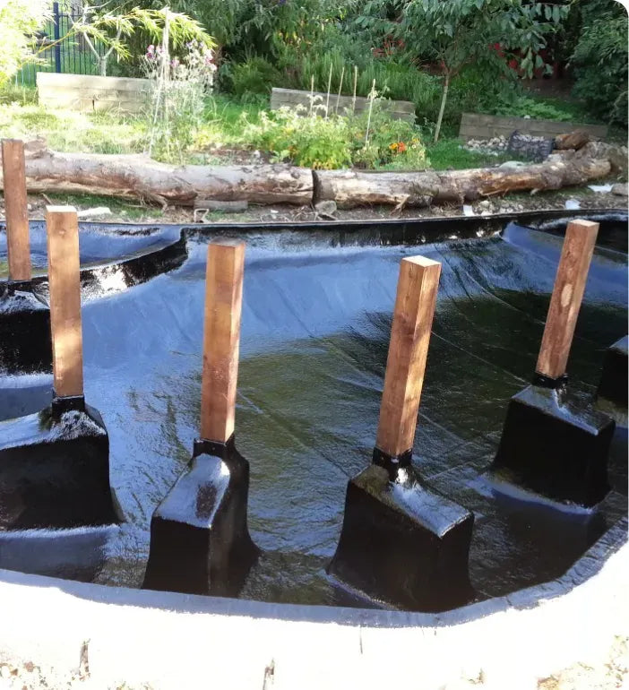 a group of wooden posts sticking out of the water