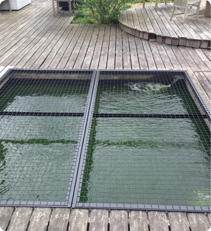 a wooden deck with a metal grate on top of it