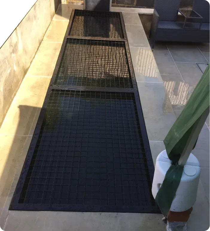 an umbrella sitting on top of a metal grate