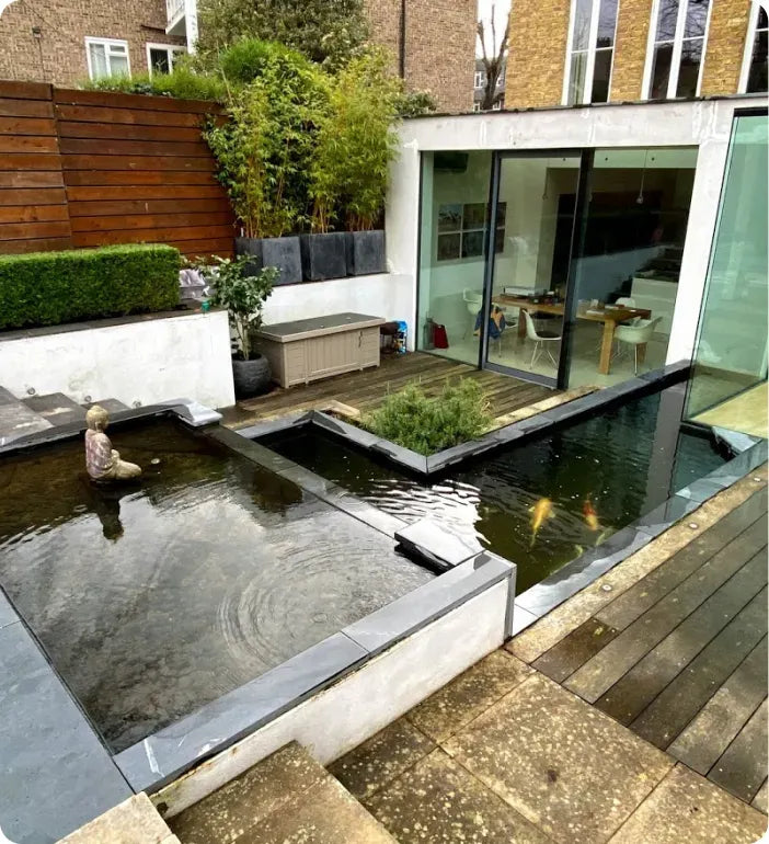 a backyard with a pond and a patio