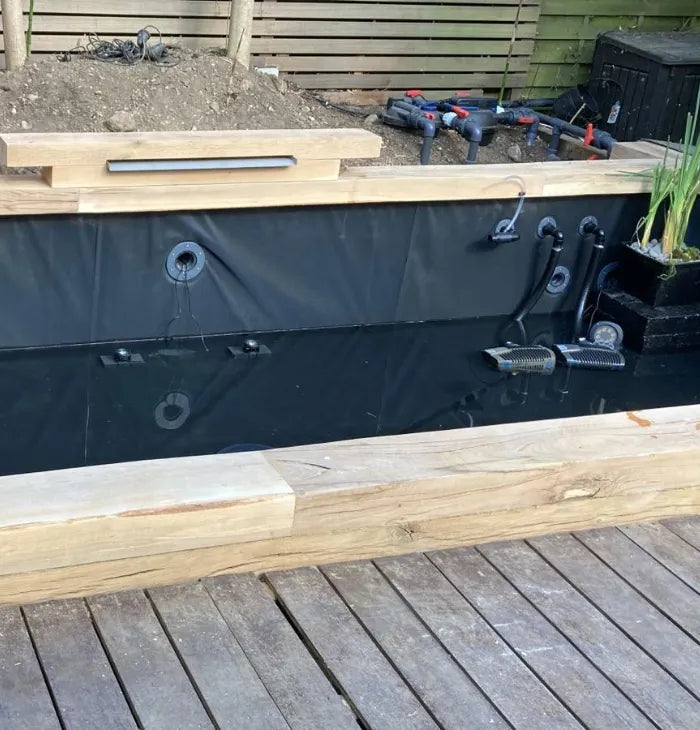 a wooden deck with a water feature in it