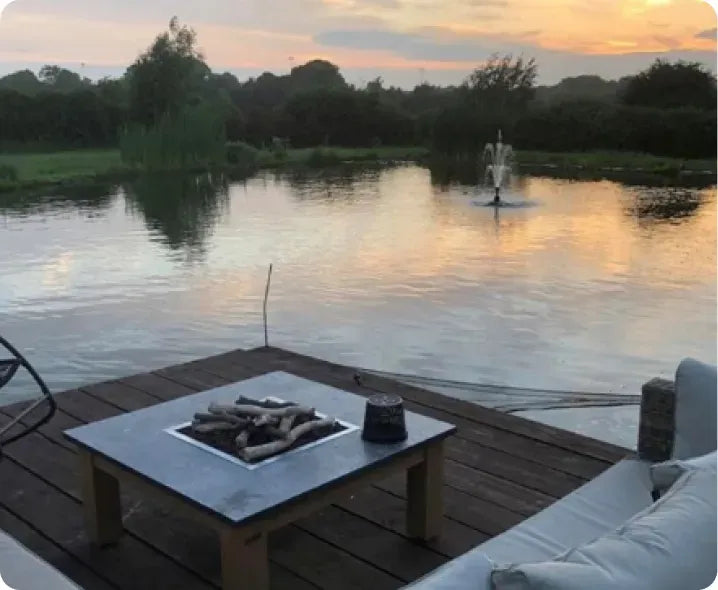 a fire pit sitting on top of a wooden dock