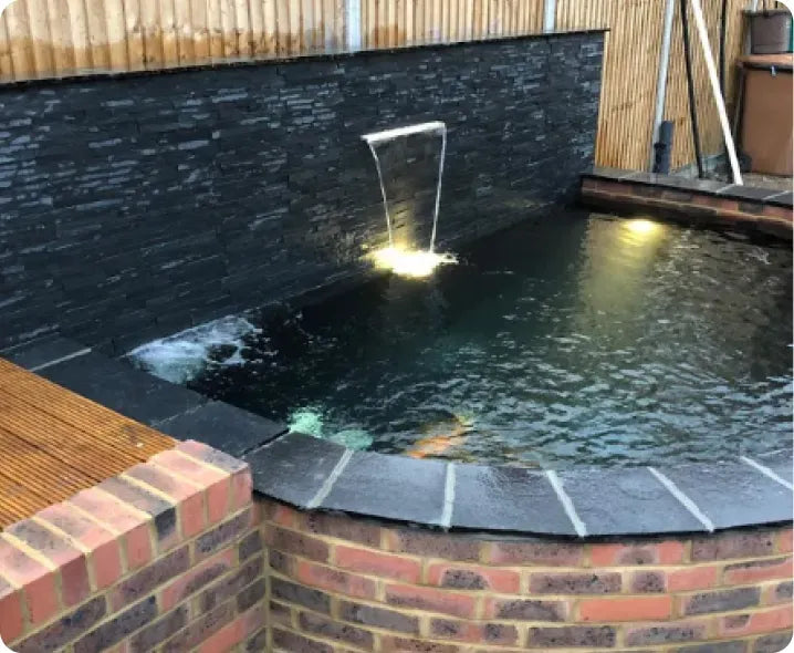 a small pool with a water feature in the middle of it