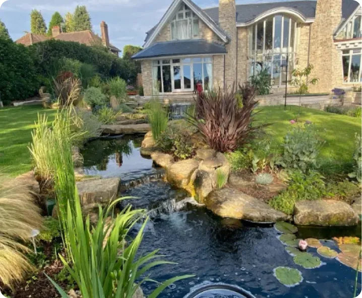 a house with a pond in front of it