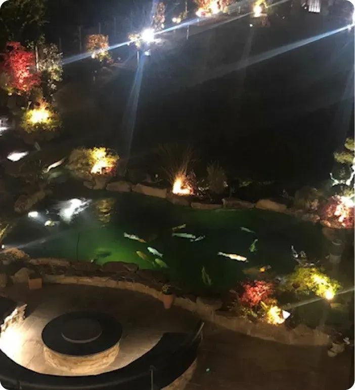 a view of a pool at night from above