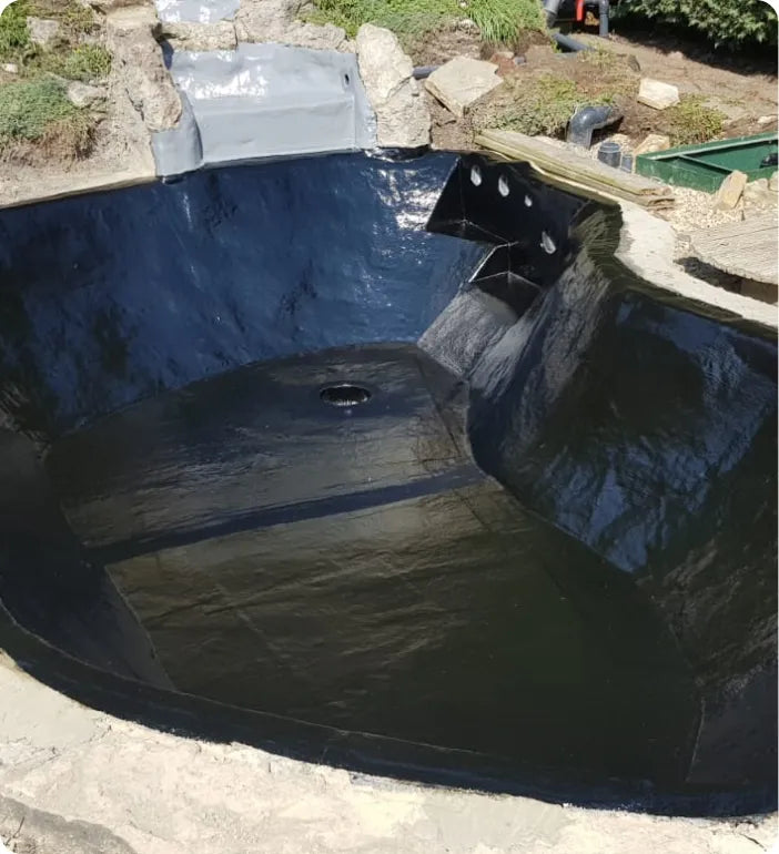 a large pool is being constructed in the middle of a yard