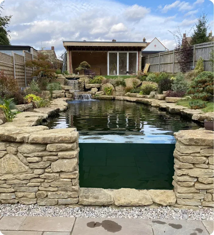 a small pond with a waterfall in the middle of it