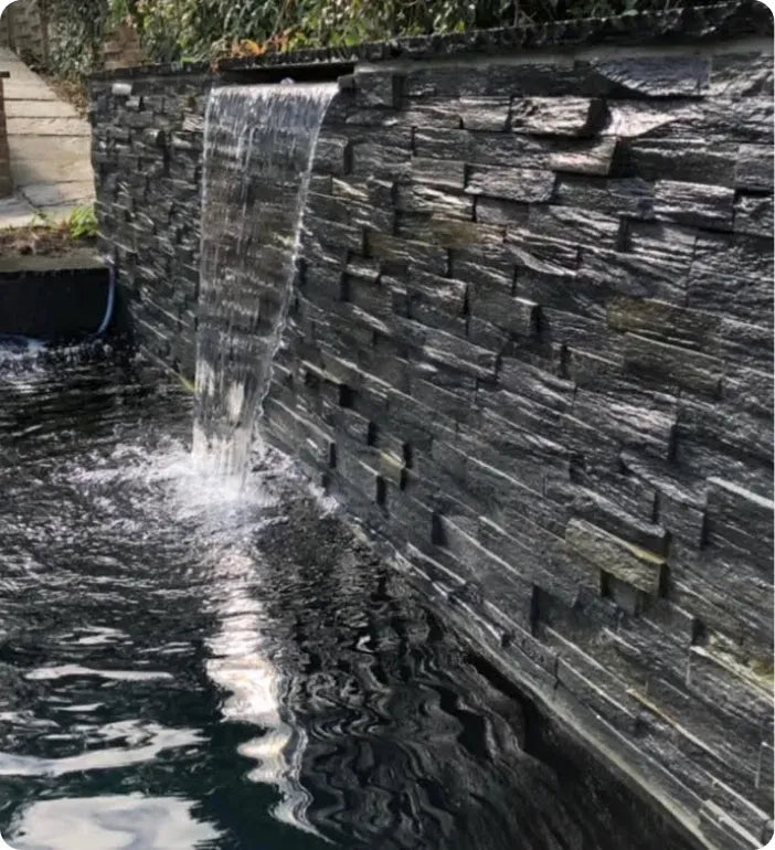 a large waterfall is coming out of the water