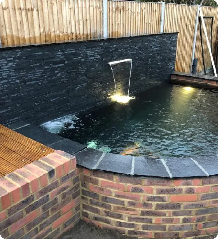 a small pool with a water feature in the middle of it