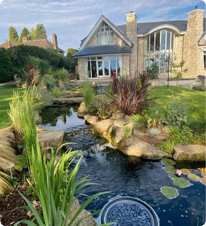 a house with a pond in front of it