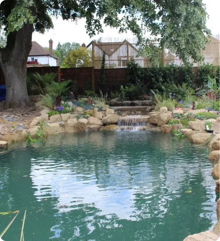 a pond with a waterfall in the middle of it