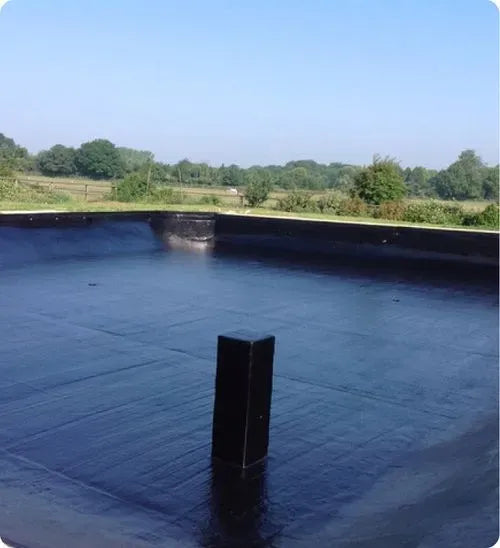 a large tarp covering a flat surface in a field