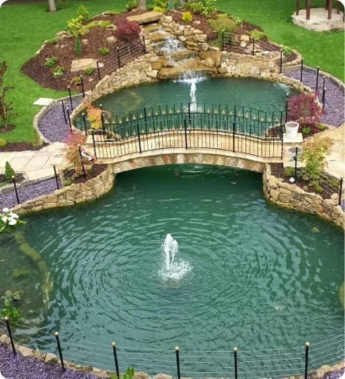 a small pond with a bridge over it