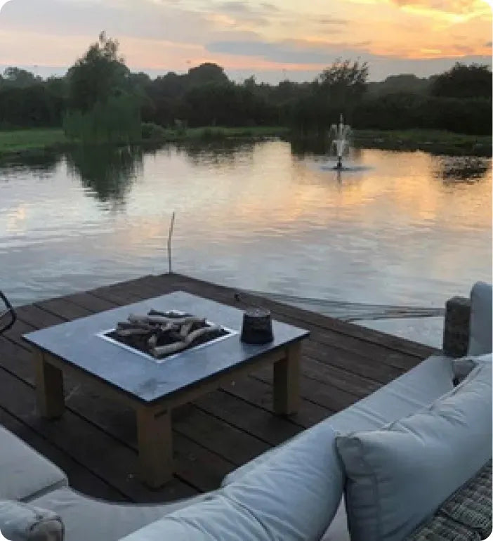 a fire pit sitting on top of a wooden dock