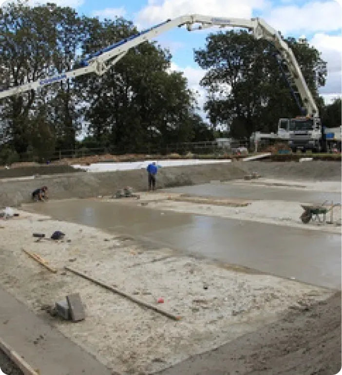 a construction site with a crane and construction workers