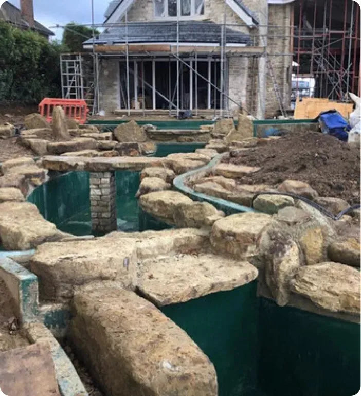 a house under construction with a pool in the middle of it