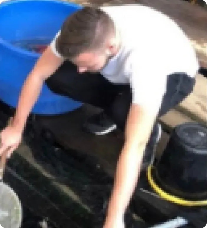 a man bending over to check on a stove