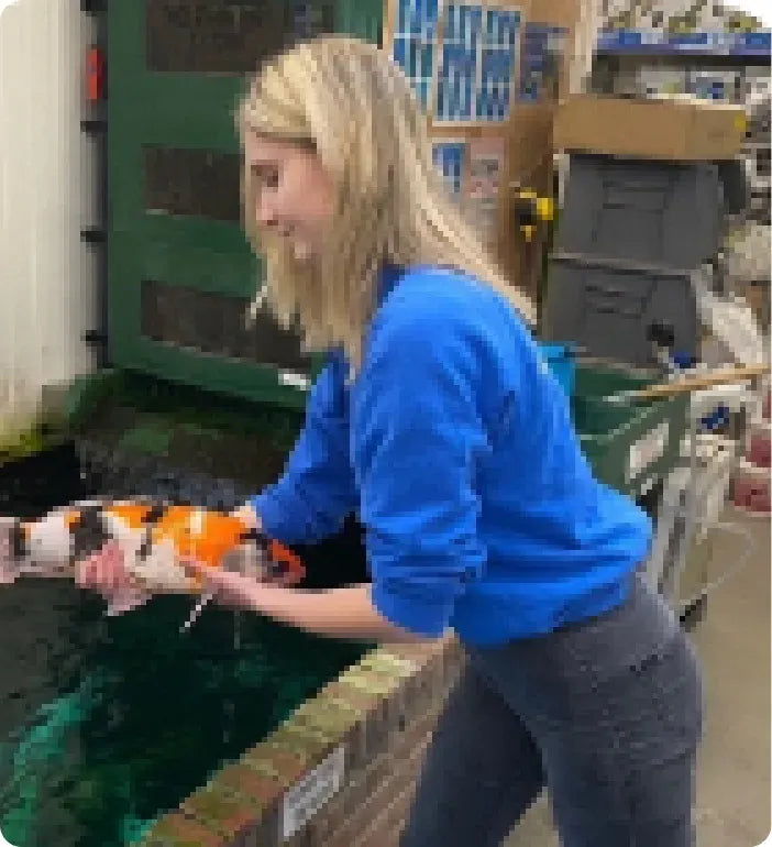 a woman holding a fish in her hands