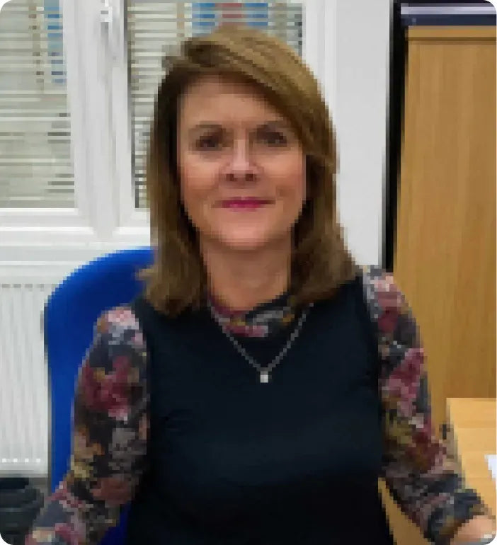 a woman sitting at a desk in an office