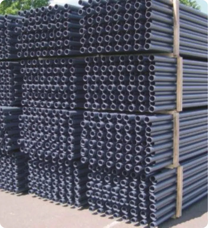 a pile of black pipes stacked on top of each other