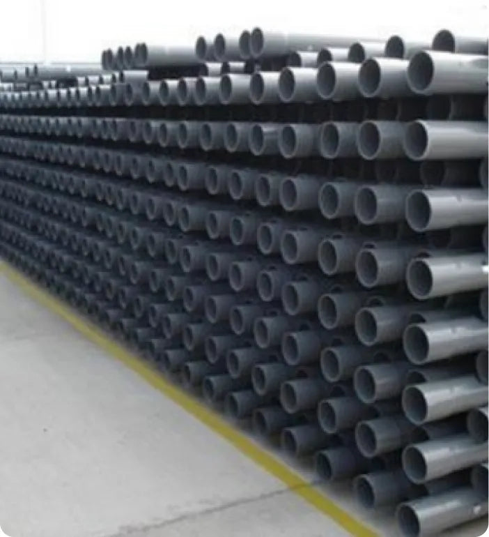 a large stack of pipes in a warehouse